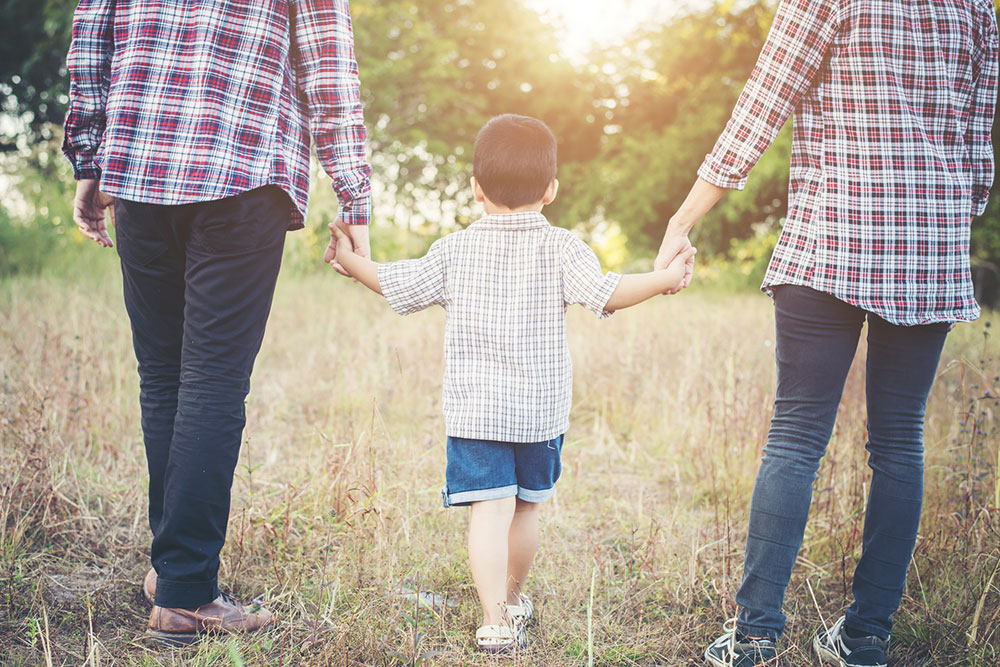 Parents spending time outdoors with their child