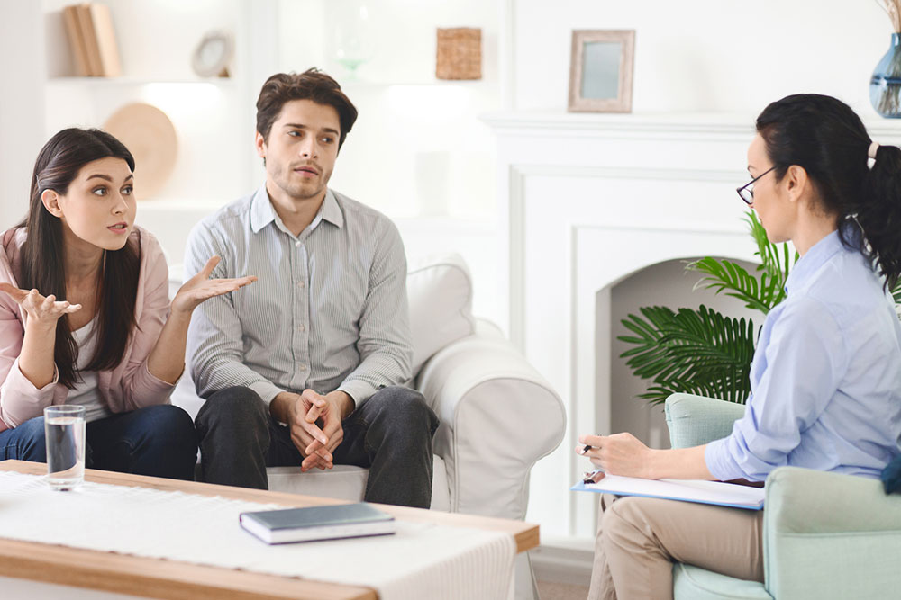 Couple speaking with a professional mediator or counselor in an office setting